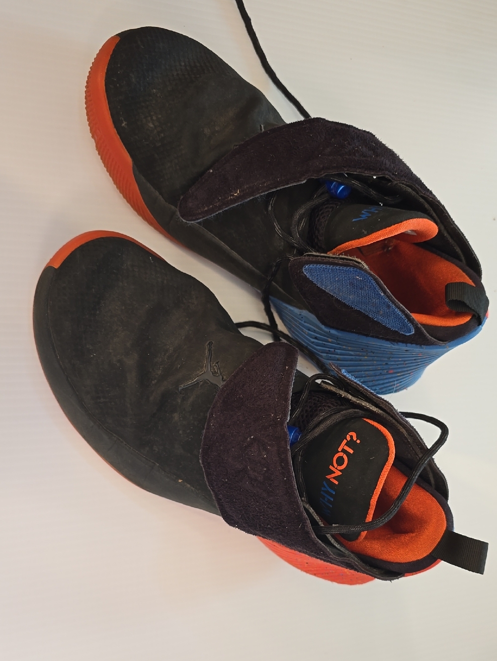 Black High-Top Sneakers with Orange Soles and Blue Accents